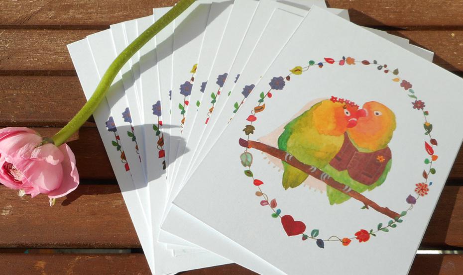 Ready-to-Write Lovebirds wedding invitations fanned out with a flower. Ready-to-Write Lovebirds wedding invitations fanned out